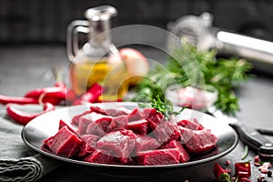 Raw beef meat sliced on black background