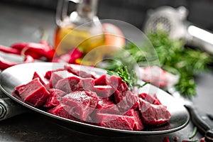 Raw beef meat sliced on black background