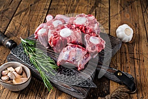 Raw beef Oxtail cut Meat on wooden cutting board with knife. wooden background. Top view