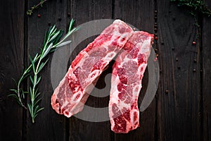 Raw beef ribs kalbi on wooden background, top view