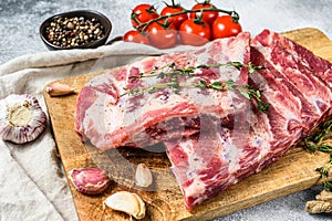 Raw beef ribs with rosemary, pepper and garlic. Gray background. Top view