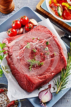 Raw beef rump steak with fresh ingredients