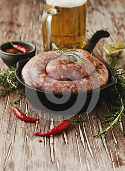 Raw beef sausages on a cast-iron pan, selective focus