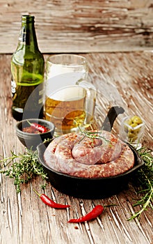 Raw beef sausages on a cast-iron pan, selective focus