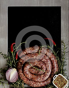 Raw beef sausages on a cast-iron pan, selective focus