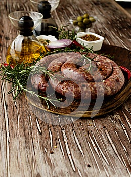 Raw beef sausages on a cast-iron pan, selective focus