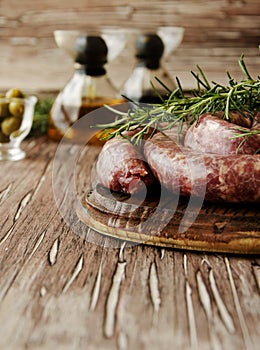 Raw beef sausages on a cast-iron pan, selective focus