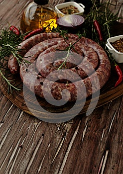 Raw beef sausages on a cast-iron pan, selective focus