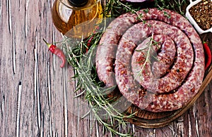 Raw beef sausages on a cast-iron pan, selective focus