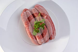 Raw beef sausages on a timber board