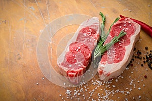 Raw beef sirloin Steak with seasoning on wooden background, preparing for BBQ