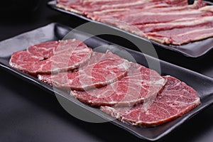 Raw beef slice for barbecue japanese style, yakiniku, meat are being cooked on stove