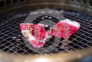 Raw beef slice on grille for barbecue or Japanese style yakiniku