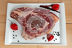 Raw beef steak from above from above on background of wood