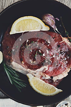 Raw beef steak closeup background with spices and herbs.