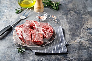 Raw beef steak on dark gray background