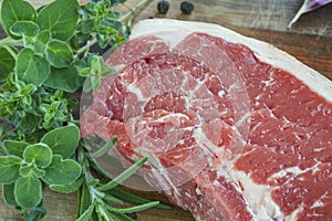 Raw Beef Steak with Fresh Herbs on Board