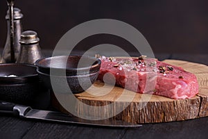 Raw beef steak with spices