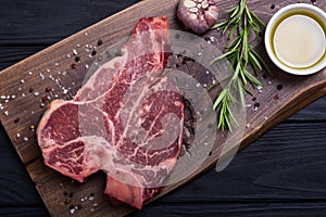 Raw beef steak T bone with ingredient