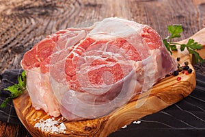 Raw beef steak on wooden board.