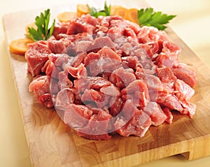 Raw beef stew. Arrangement on a cutting board.