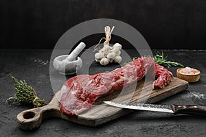 Raw beef tri-tip loin on cutting board