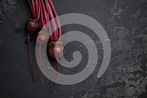 Raw beetroot with herbage leaves on a dark background. banner, menu, recipe place for text, top view