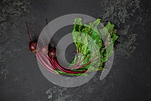 Raw beetroot with herbage leaves on a dark background. banner, menu, recipe place for text, top view photo