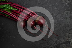 Raw beetroot with herbage leaves on a dark background. banner, menu, recipe place for text, top view