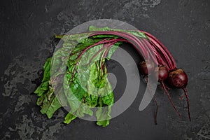 Raw beetroot with herbage leaves on a dark background. banner, menu, recipe place for text, top view