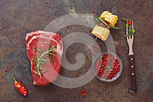 Raw black angus steak with vegetable and seasonings