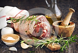 Raw boneless lamb leg with garlic and rosemary