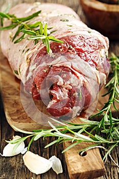 Raw boneless lamb leg with garlic and rosemary