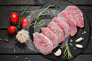 Raw boneless pork chops, vegetables, herbs and spices