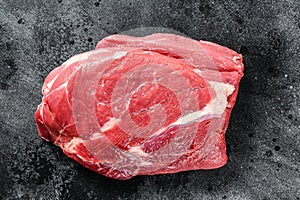 Raw brisket beef cut. Black Angus beef. Black background. Top view.