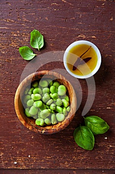 Raw broad beans end olive oil