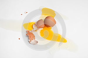 Raw broken egg on white background, top view
