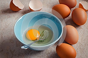 Raw broken egg with yolk in bowl