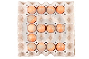 Raw brown Chicken Eggs In paper container tray box arranged English alphabet is ` E `.