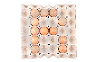 Raw brown Chicken Eggs In paper container tray box arranged English alphabet is ` R `.