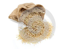 Raw brown rice in brown sack, healthy food.