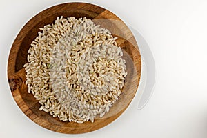 Raw brown rice in the wooden bowl