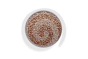 Raw buckwheat in bowl on white background isolated. Top view