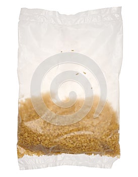 Raw bulgur grains in a cellophane transparent bag on an isolated background