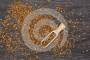 Raw bulgur grains on grey stone