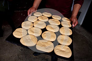 Raw buns dough on a metal baking sheet