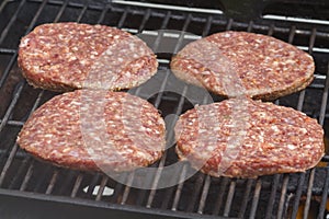 Raw Burgers on a Barbecue
