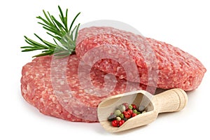 Raw burgers, rosemary and pepper
