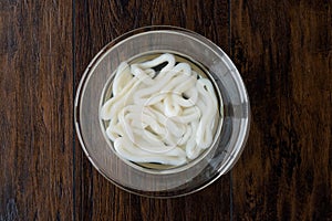 Raw Calamari Squid Rings in Water with Glass Bowl.