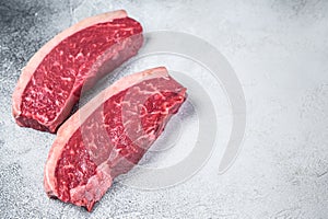 Raw cap rump or top sirloin beef meat steak. White background. Top view. Copy space